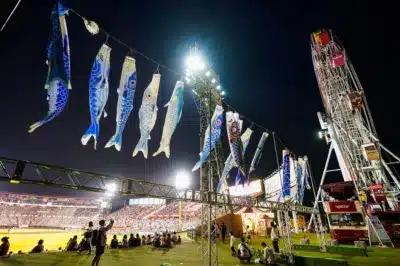 青い鯉のぼりがライトアップされた野球場
