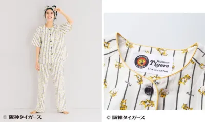 阪神タイガースのロゴとトラ柄がデザインされたストライプ柄のパジャマを着た女性が、笑顔でポーズをとっている画像です。快適な着心地をアピールする部屋着のイメージが伝わります。